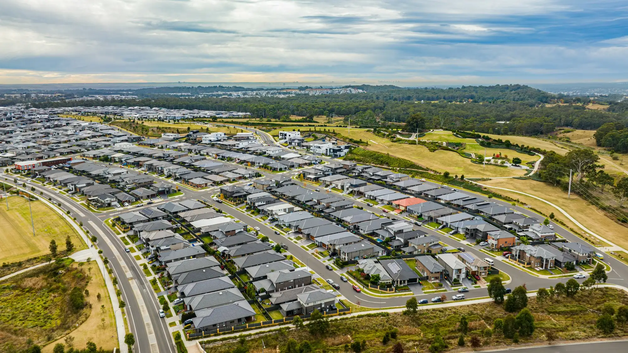 Aerial view of a new housing estate with homes and vacant lots