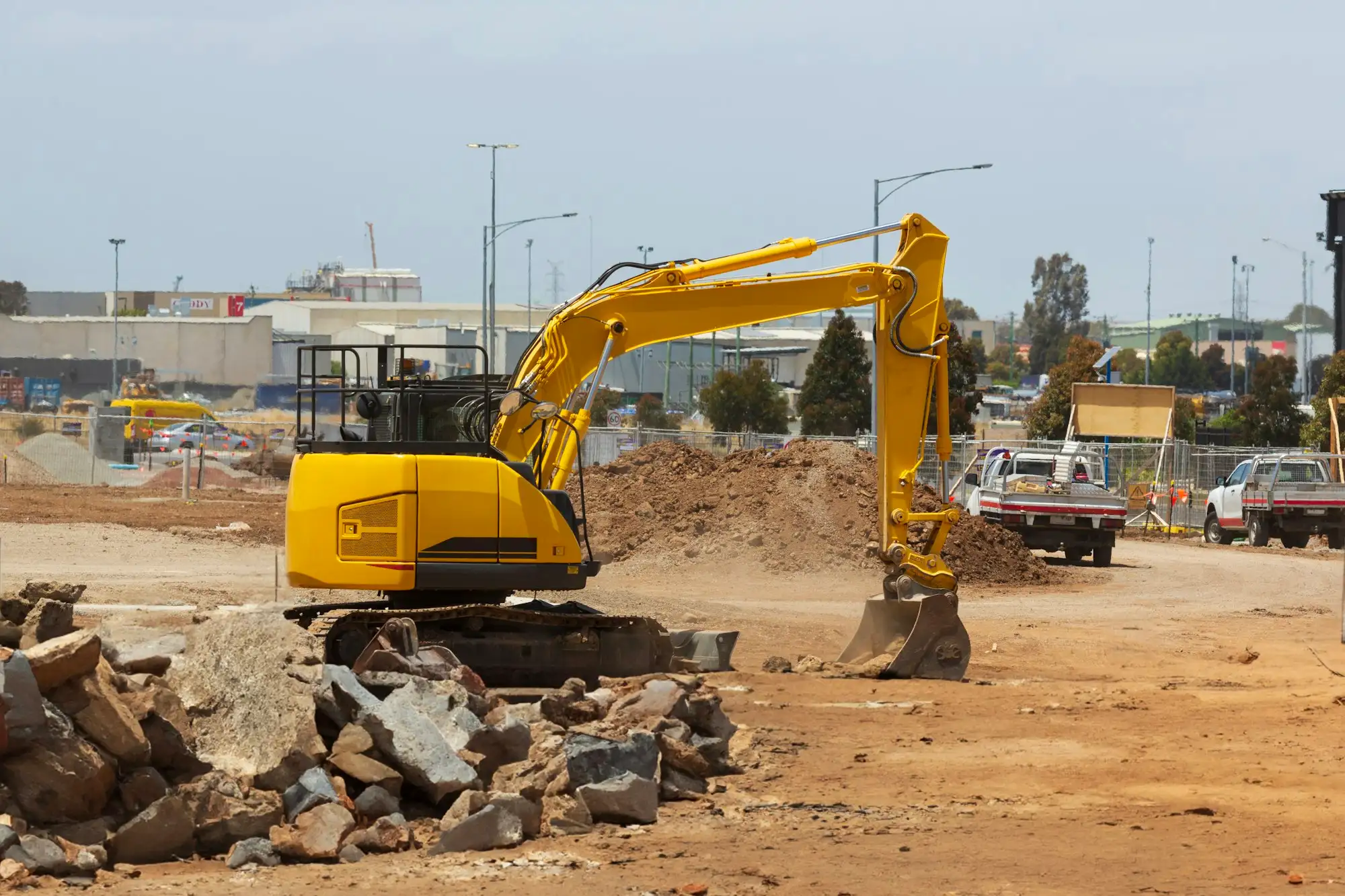 Excavator preparing a vacant residential lot for a new home