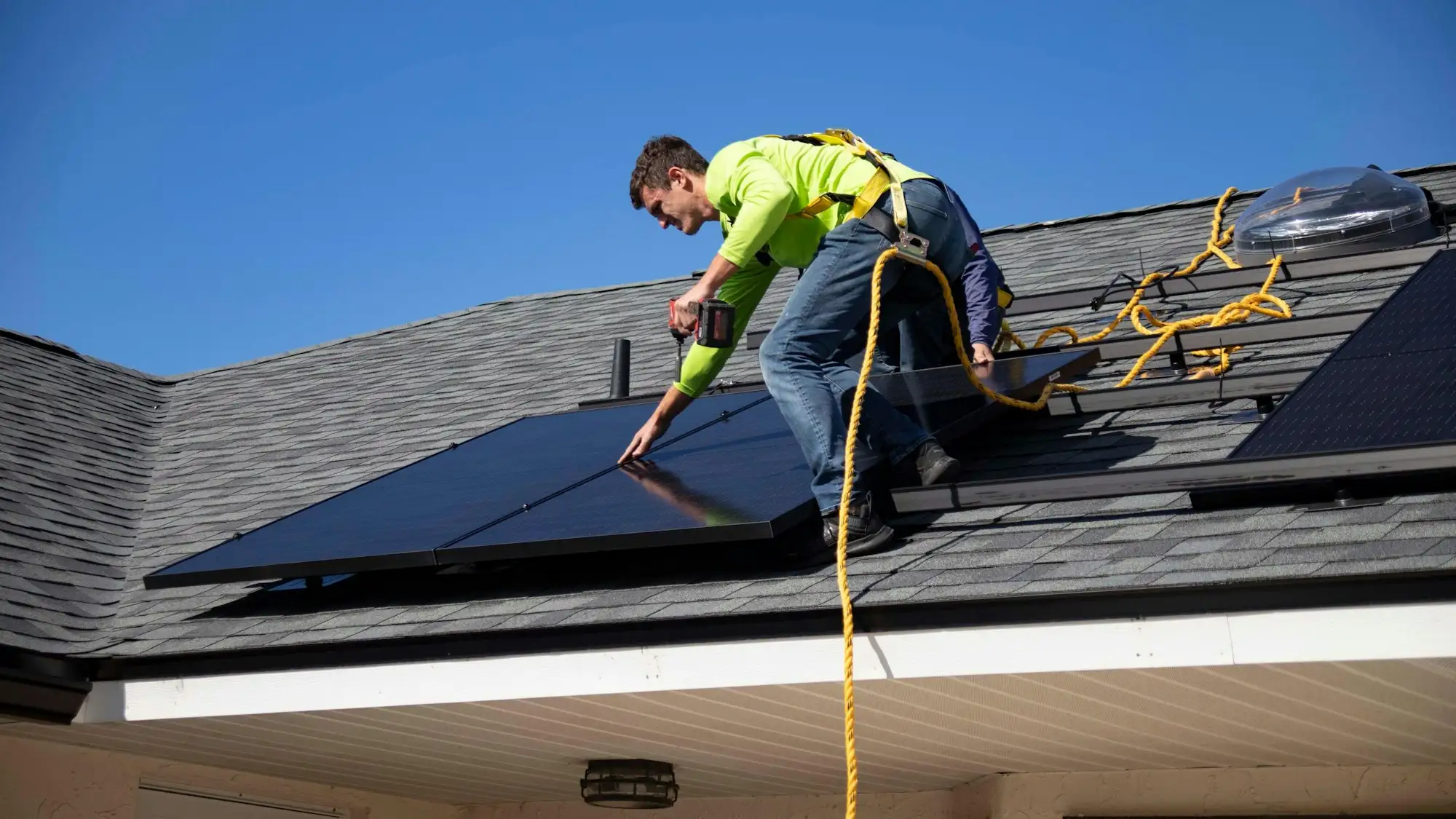 Solar installer fitting panels on an Australian residential roof
