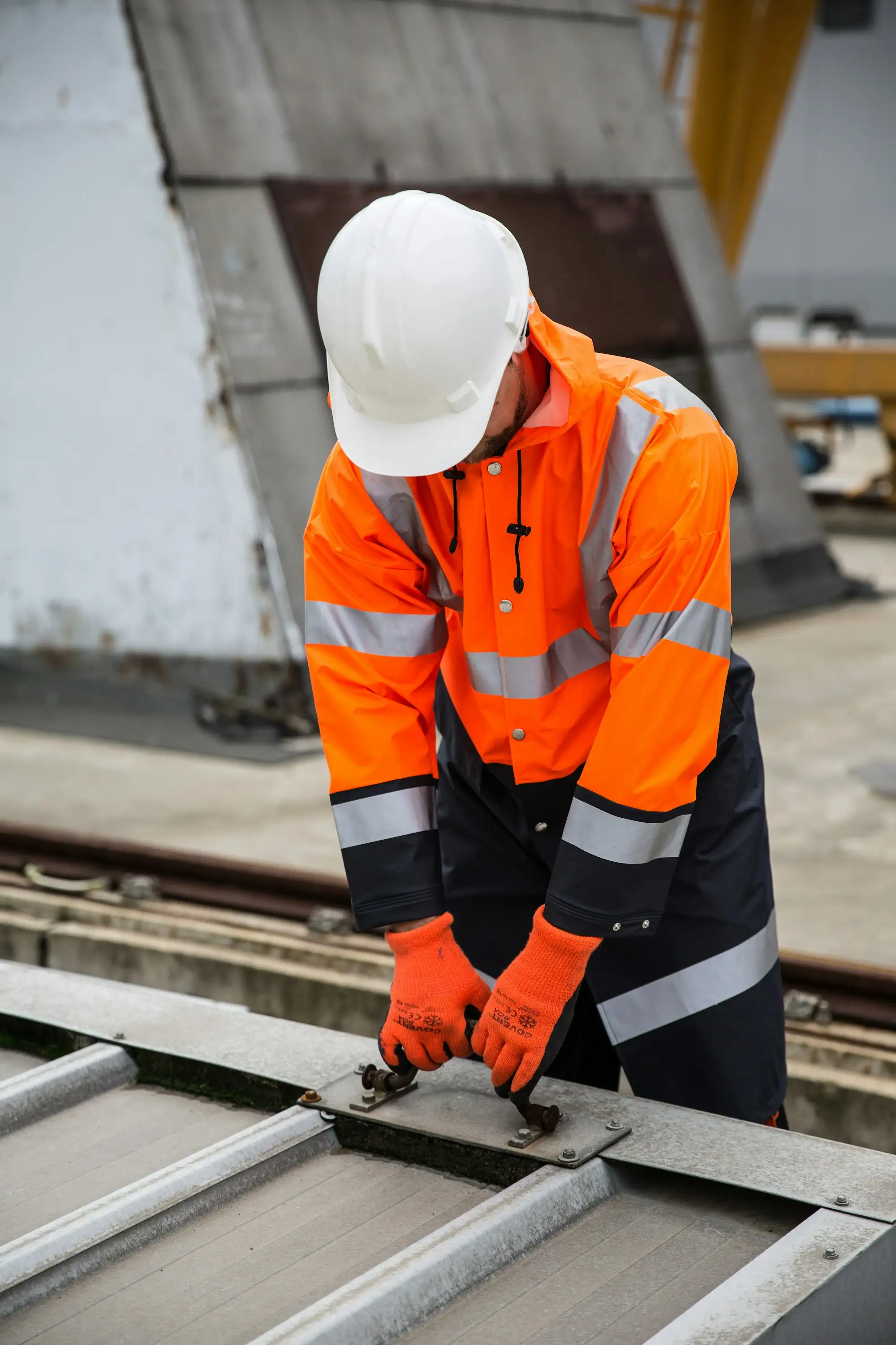 Tradie in orange hi vis workwear on an Australian building site