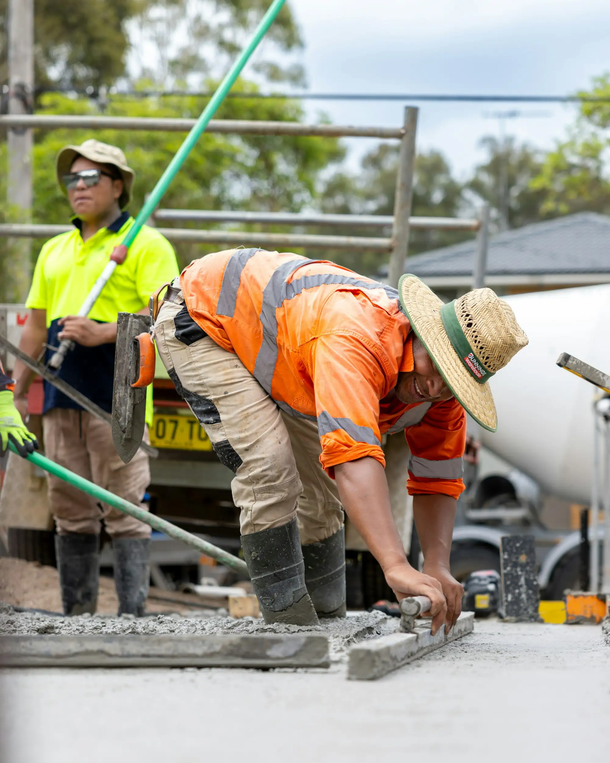 Tradies in hi-vis working on an Australian building site