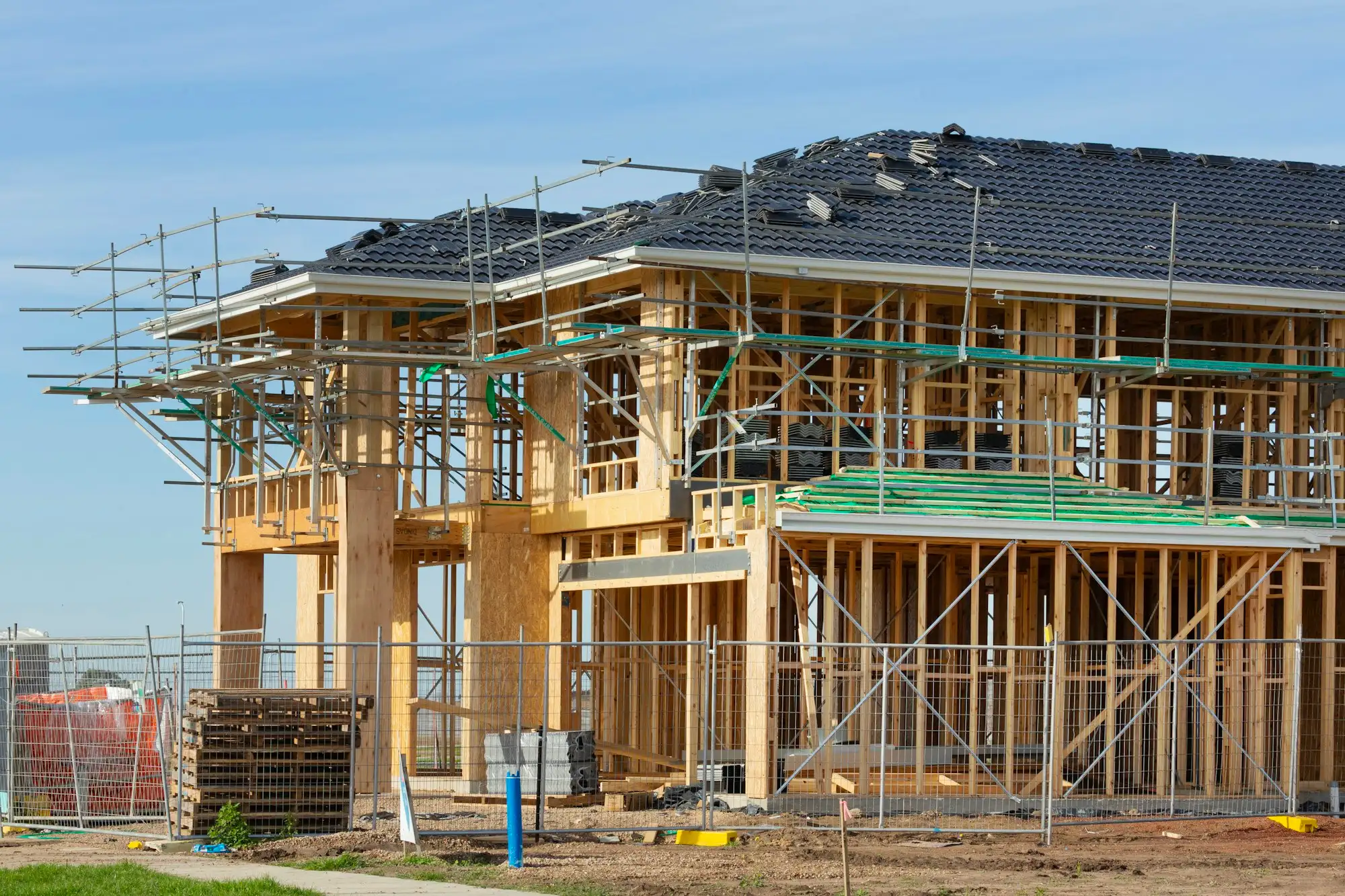 Two storey home being framed on an Australian housing estate
