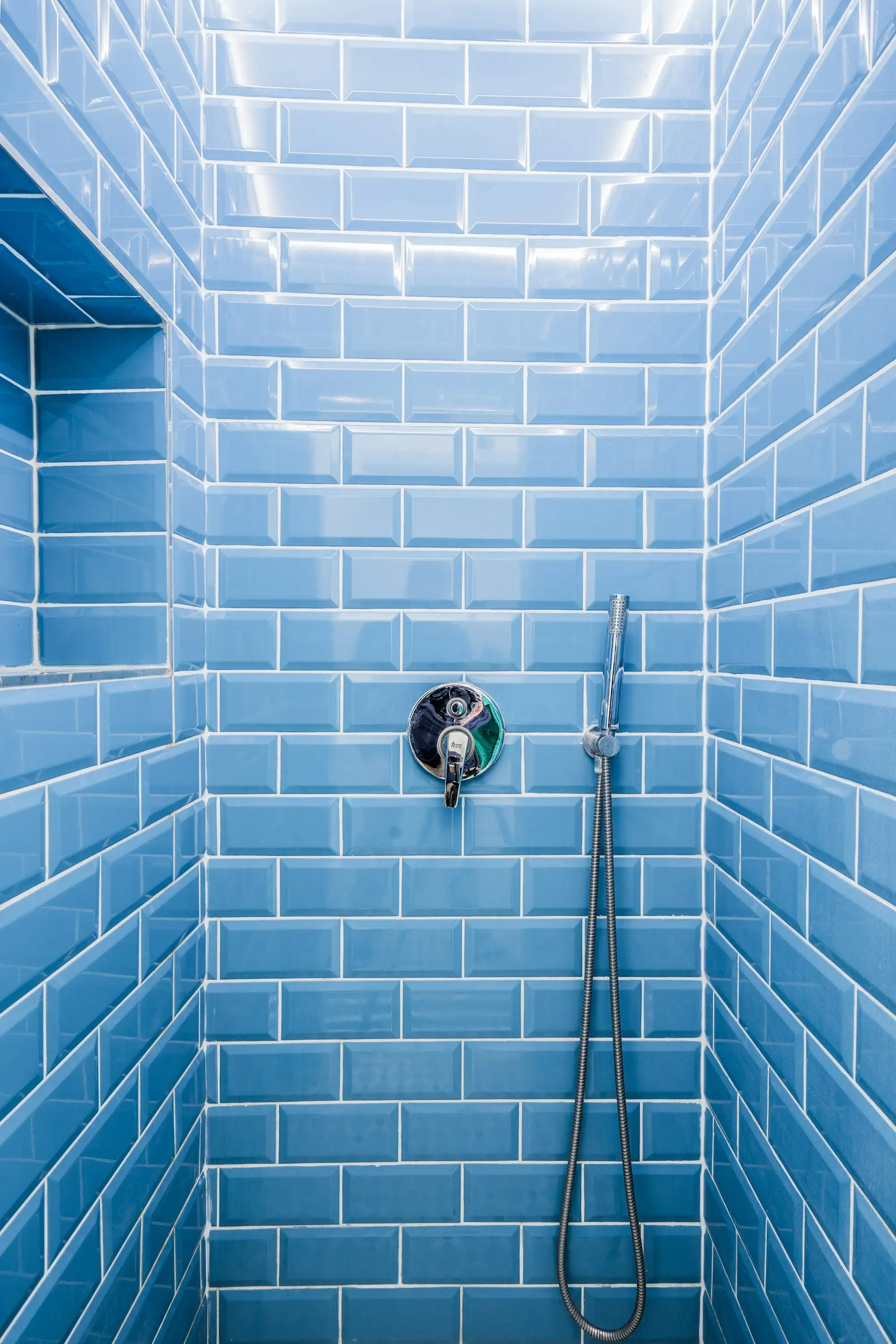 Tiler laying wall tiles in a new Australian bathroom